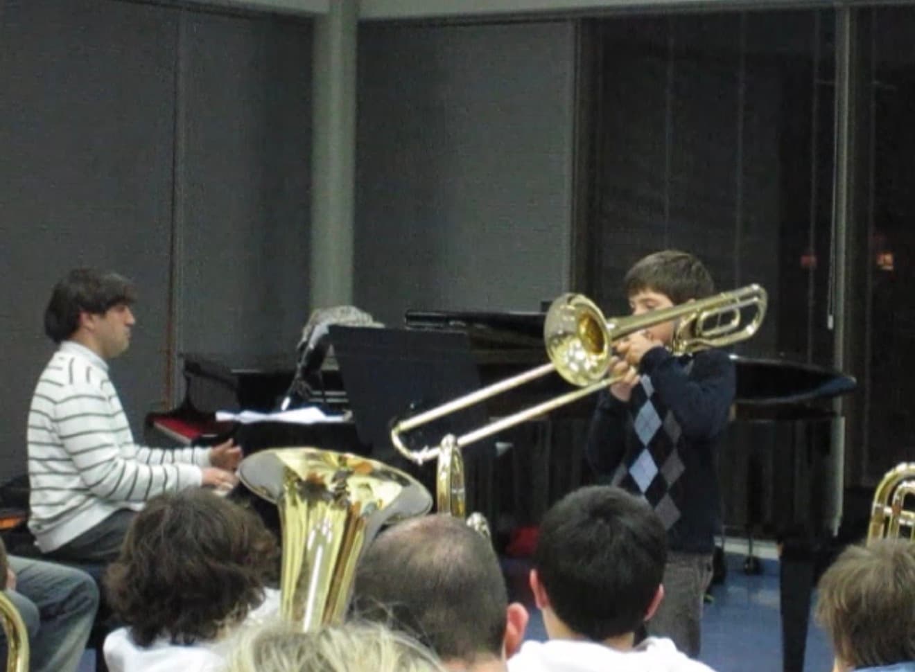 Víctor as a child playing trombone